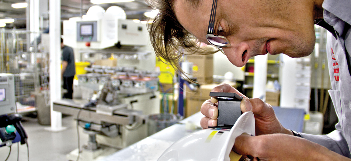 Man checking quality of helmet in lab