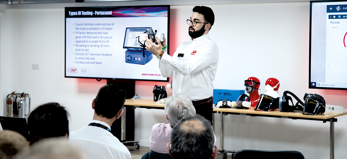 A picture of a trainer from JSP Limited providing face fit testing support to a group of individuals